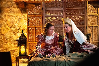 Production photo of Juliet and Lady Capulet on her bed. Photo by Kenneth Garrett